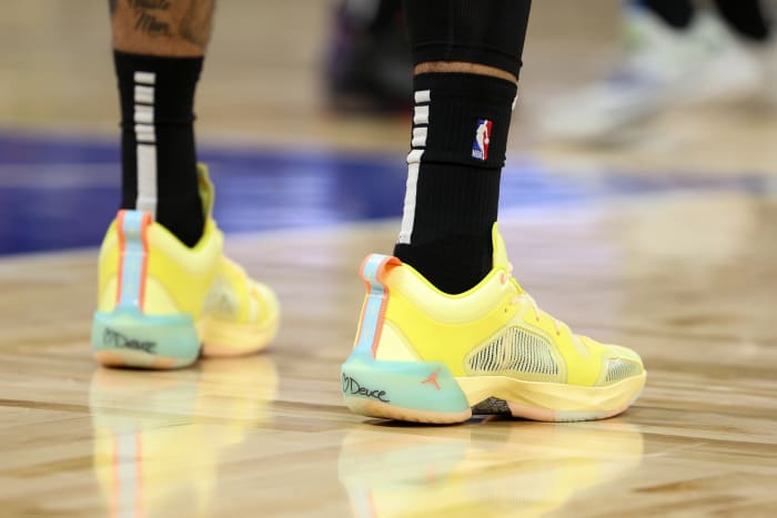 View of yellow and blue Air Jordan shoes.